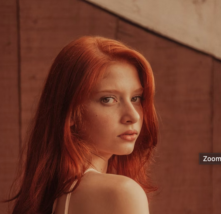 Red haired woman looking back